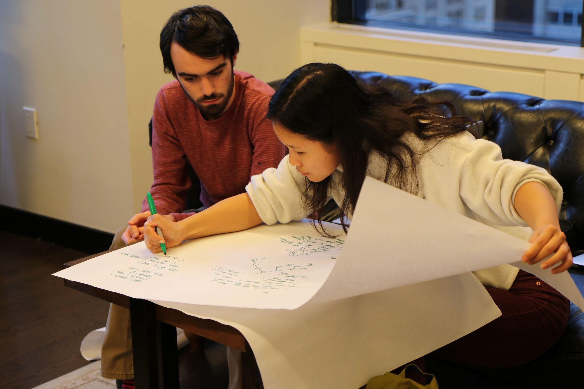 Student doing a mock technical interview with a volunteer engineer at Company.